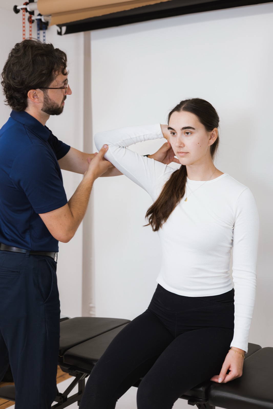 Tom moving a patient's arm through its range while supporting the shoulder