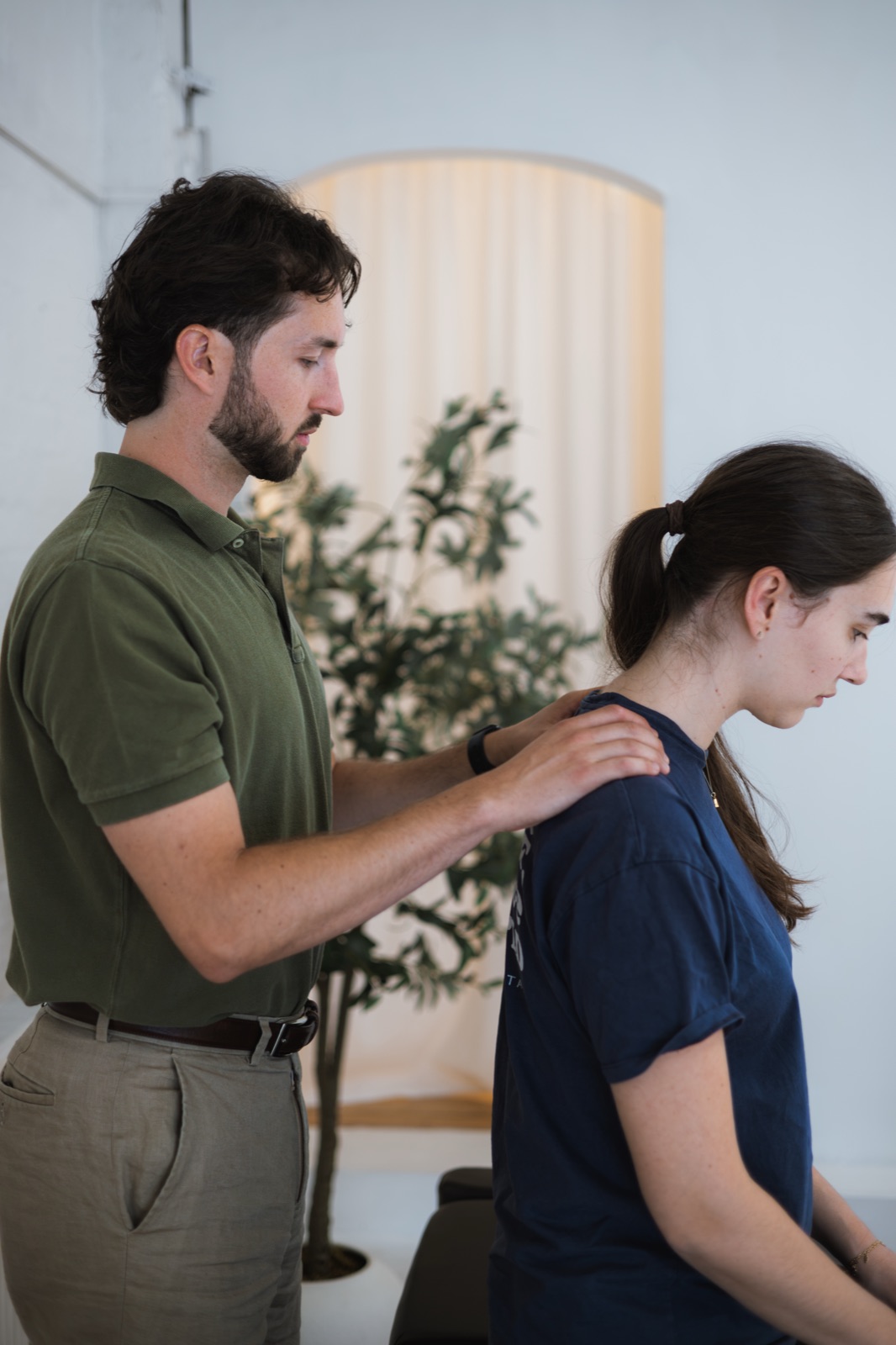Tom feeling across a patient's shoulders and upper back